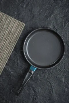 Empty frying pan for cooking placed on black background Stock Photos
