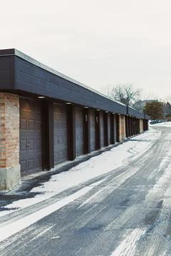 Empty garage doors in a row on a cold winter day Stock Photos