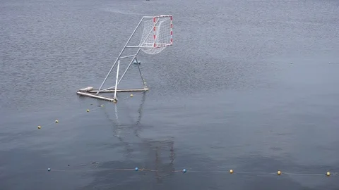 Empty gates for Canoe polo float on the calm river surface Видео 109208285