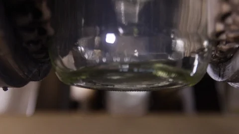 Empty glass bottle jars transported by conveyor belt in factory to be filled Stock Footage 112883833