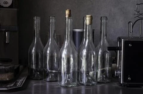 Empty glass bottles, coffee machine, kitchen bar items Stock Photos