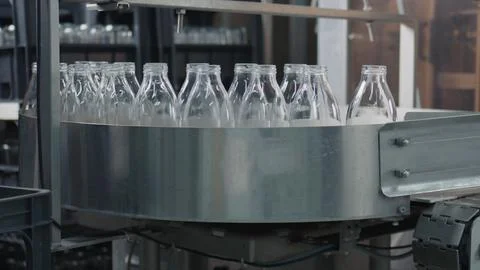 Empty glass bottles moving on conveyor belt in dairy factory Stock Illustration