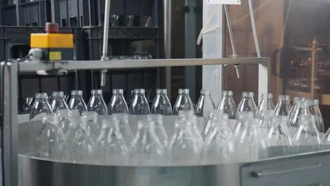 Empty glass bottles moving on conveyor belt in dairy factory Stock Illustration