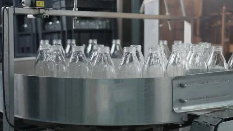 Empty glass bottles moving on conveyor belt in dairy factory Stock Illustration