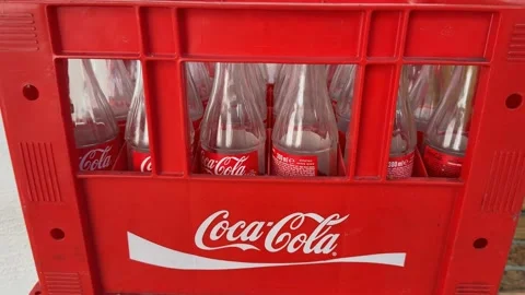 Empty glass bottles in red crate with iconic logo design Stock Footage 330927443