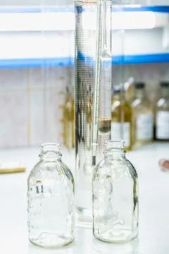 Empty glass bottles on table in laboratory Foto stock