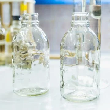 Empty glass bottles on table in laboratory Stock Photos