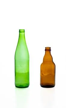 Empty glass bottles on white background.  Green and brown bottles stand sid.. Stock Photos