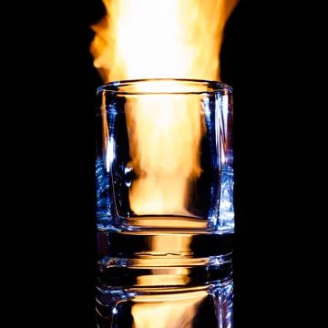 Empty glass of brandy on fire, isolate Stock Photos