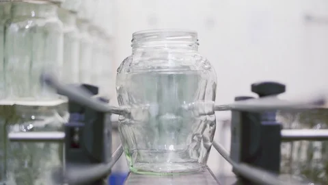 Empty Glass cans on automatic line for processing vegetables. Stock Footage 129263733