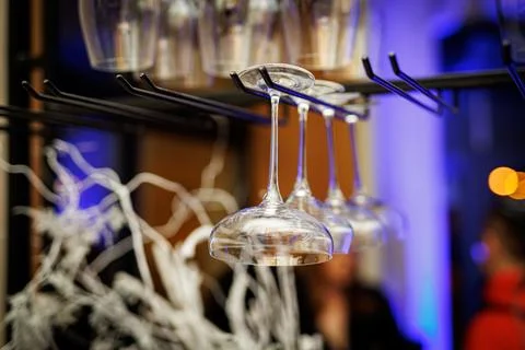 Empty glass clean upside-down stemware in nightclub or a restaurant. Stock Photos