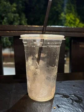 Empty glass for cold drinks with straw Stock Photos