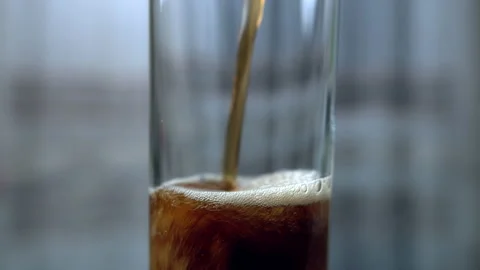 Empty glass cup close-up, pouring dark soda, gas bubbles, camera movement Stock Footage 131886930
