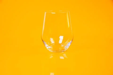 Empty glass empty jar empty ice bucket on orange background Stock Photos