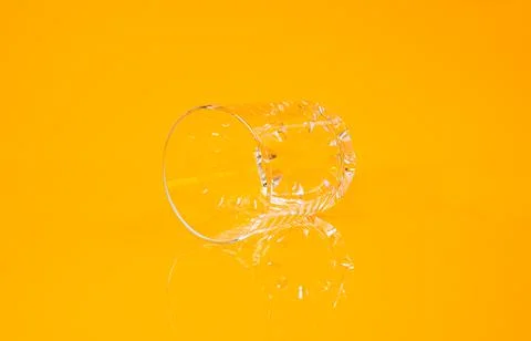 Empty glass empty jar empty ice bucket on orange background Stock Photos