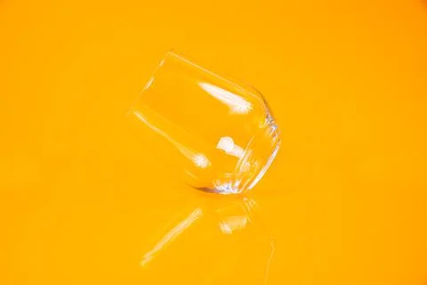 Empty glass empty jar empty ice bucket on orange background Stock Photos