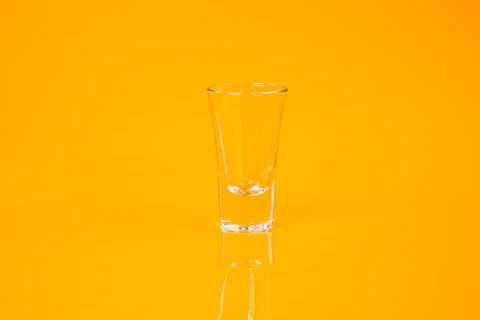 Empty glass empty jar empty ice bucket on orange background Stock Photos