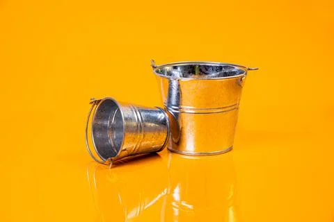 Empty glass empty jar empty ice bucket on orange background Stock Photos