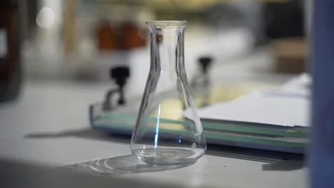 Empty glass flask on table in science lab Stock Footage 104076708