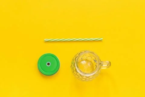 Empty glass jar in form of pineapple with green lid and straw for fruit or ve Stock Photos