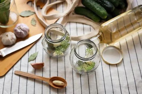 Empty glass jars and ingredients prepared for canning on tablecloth, above vi Stock Photos