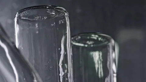 Empty glass jars creating abstract shapes on dark background 库存插图