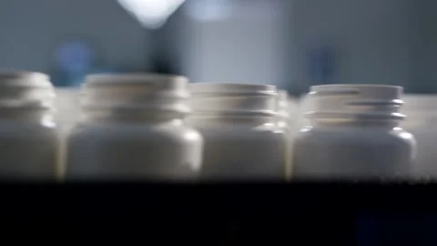 Empty Glass Jars With White Caps Standing in Row, Dark Filling Room, Macro Shot Stock Footage 341331546