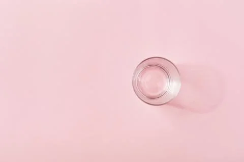 Empty glass on a light pink background Stock-Fotos
