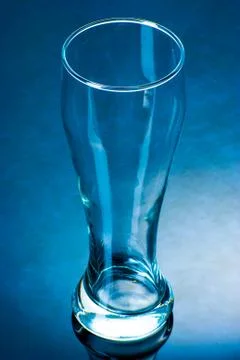 An empty glass on a reflective surface Stock Photos