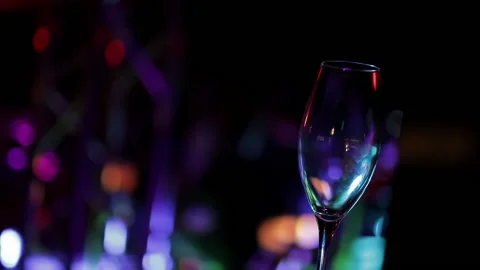 Empty glass on the table against the background of the nightclub Stock Footage 162724710