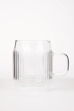Empty glass tea mug closeup on white background Stock Photos
