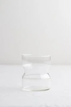 Empty glass on a white table Stock Photos