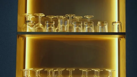Empty glasses and glasses for champagne and whiskey are on a shelf Video stock 165239871