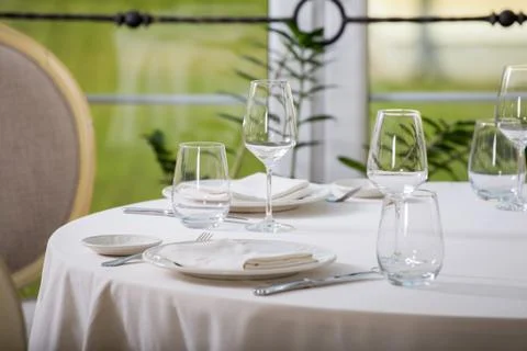 Empty glasses and plates installed in the restaurant, the restaurant served t Stock Photos