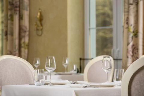 Empty glasses and plates installed in the restaurant, the restaurant served t Stock Photos