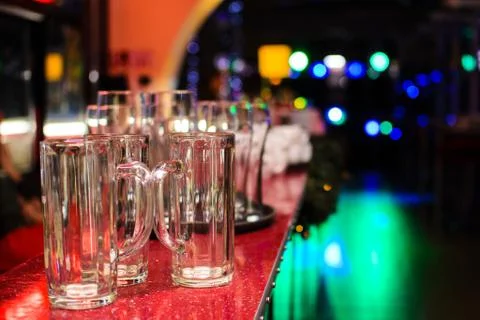 Empty glasses in a bar on a background of lights Stock Photos