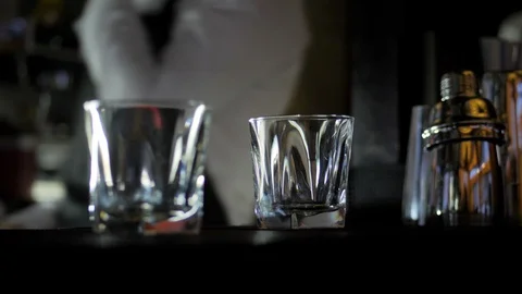Empty glasses on bar counter in night club Stock Footage 124610347