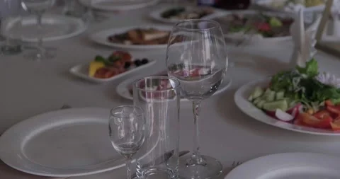 Empty glasses on the festive table. Light disco lanterns Stock Footage 221085690