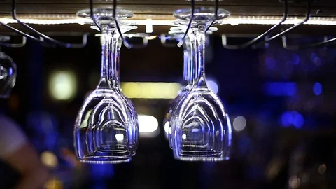 Empty glasses hang over the bar Stock Footage 92581281