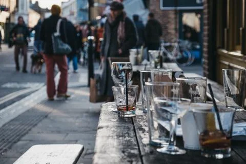 Empty glasses at an outdoor table of a pub in London, UK. Stock Photos