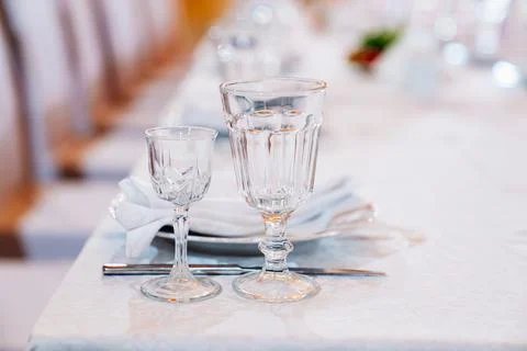 Empty glasses on the served festive table. etiquette and serving lessons. Stock Photos