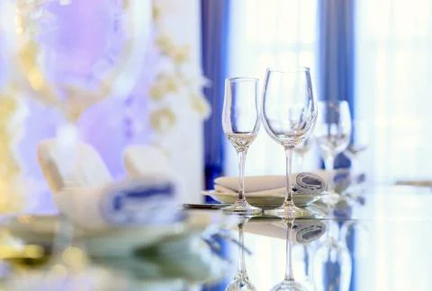 Empty glasses set in restaurant. Part of interior Stock Photos