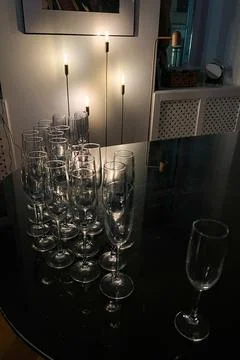 Empty glasses on a table in a dark room Stock Photos