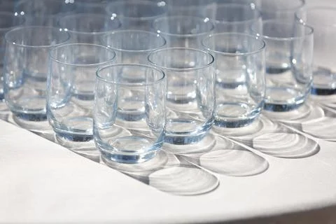 Empty glasses waiting on table in bright sunlight 库存照片