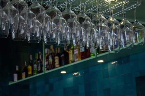 Empty glasses for wine on top of a bar shelf. Stock Photos