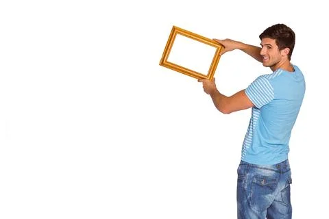 Empty gold picture frame is being angled outward on right side of studio Stock Photos