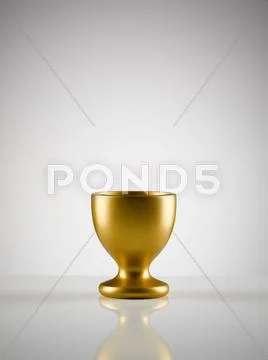 Empty golden egg cup holder against white background Stock Photos