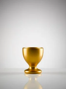 Empty golden egg cup holder against white background Stock Photos