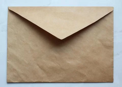 An empty golden envelope on the table Stock Photos