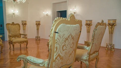 Empty golden fabric chairs inside white room with parquet floors, close up Stock Footage 130120738